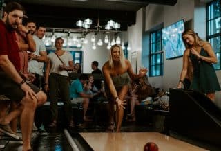 women and men playing inside room