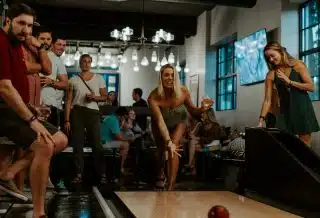 women and men playing inside room