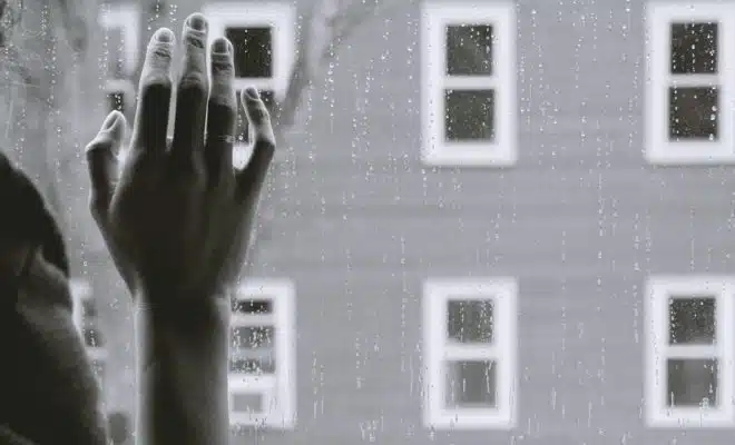 grayscale photo of woman right hand on glass